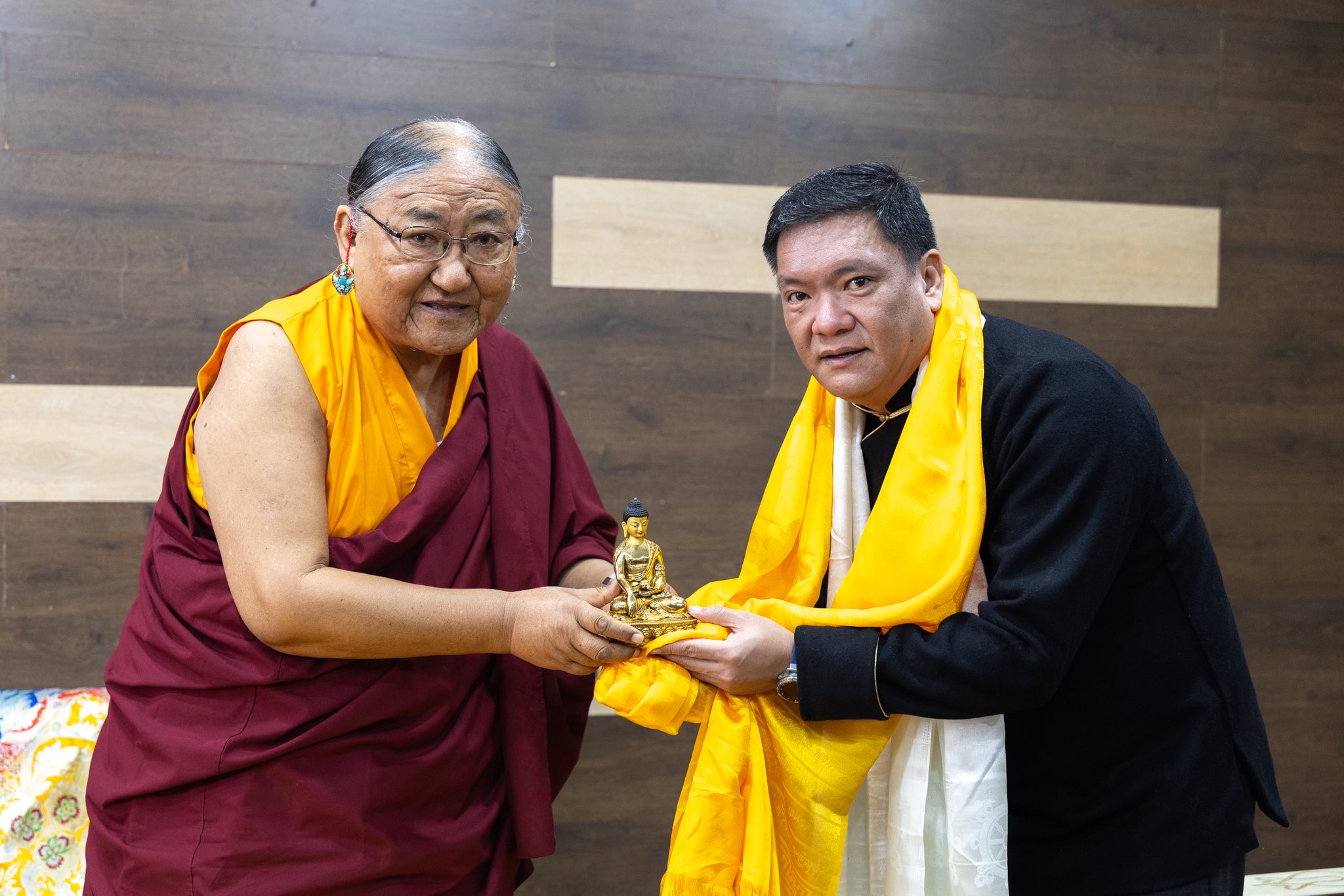 His Holiness presenting a golden Buddha statue